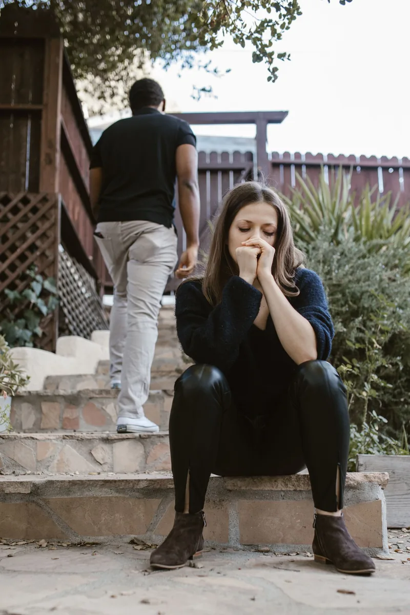 Person reflecting alone after a difficult relationship rupture