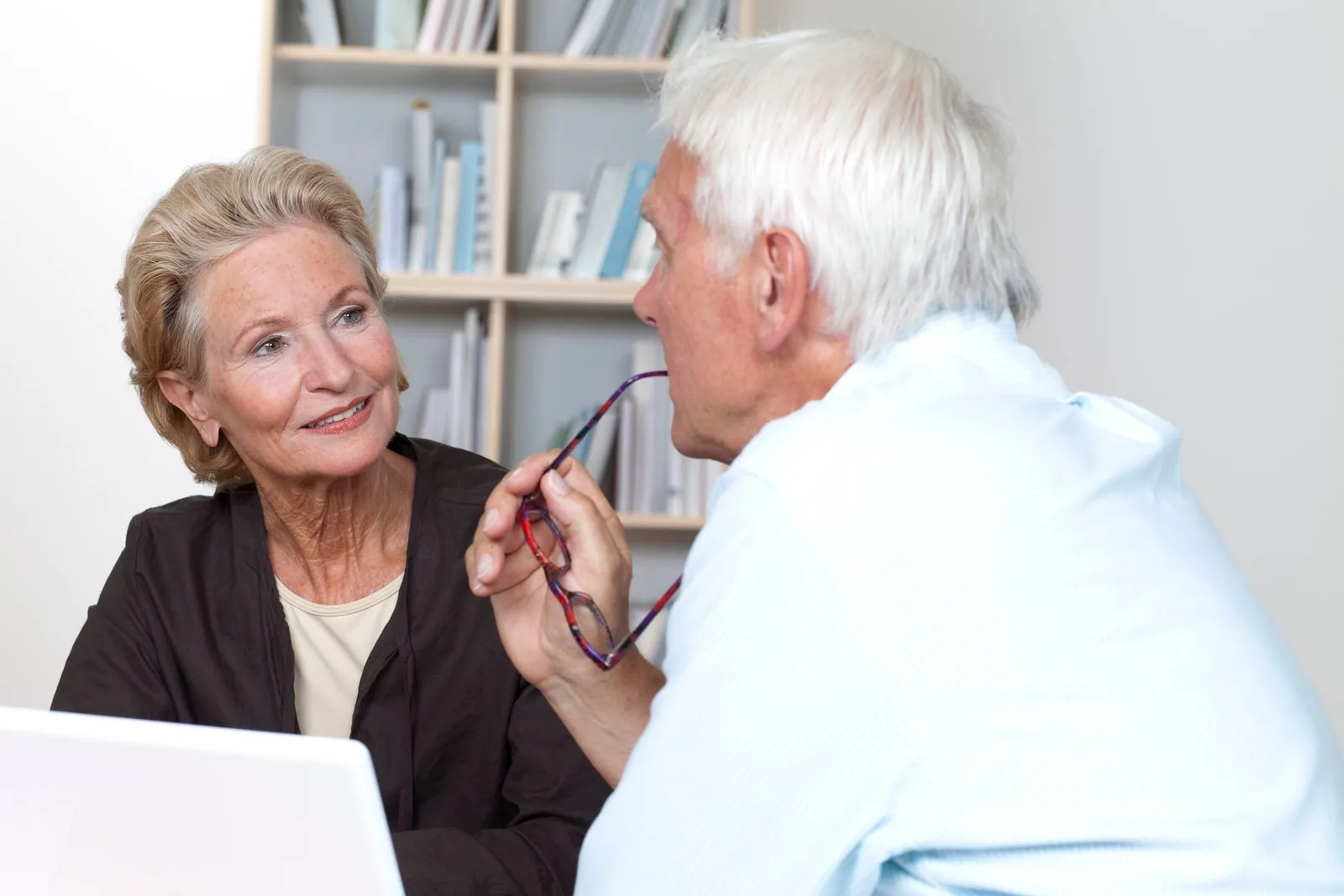 Adult couple having a warm, private conversation at home