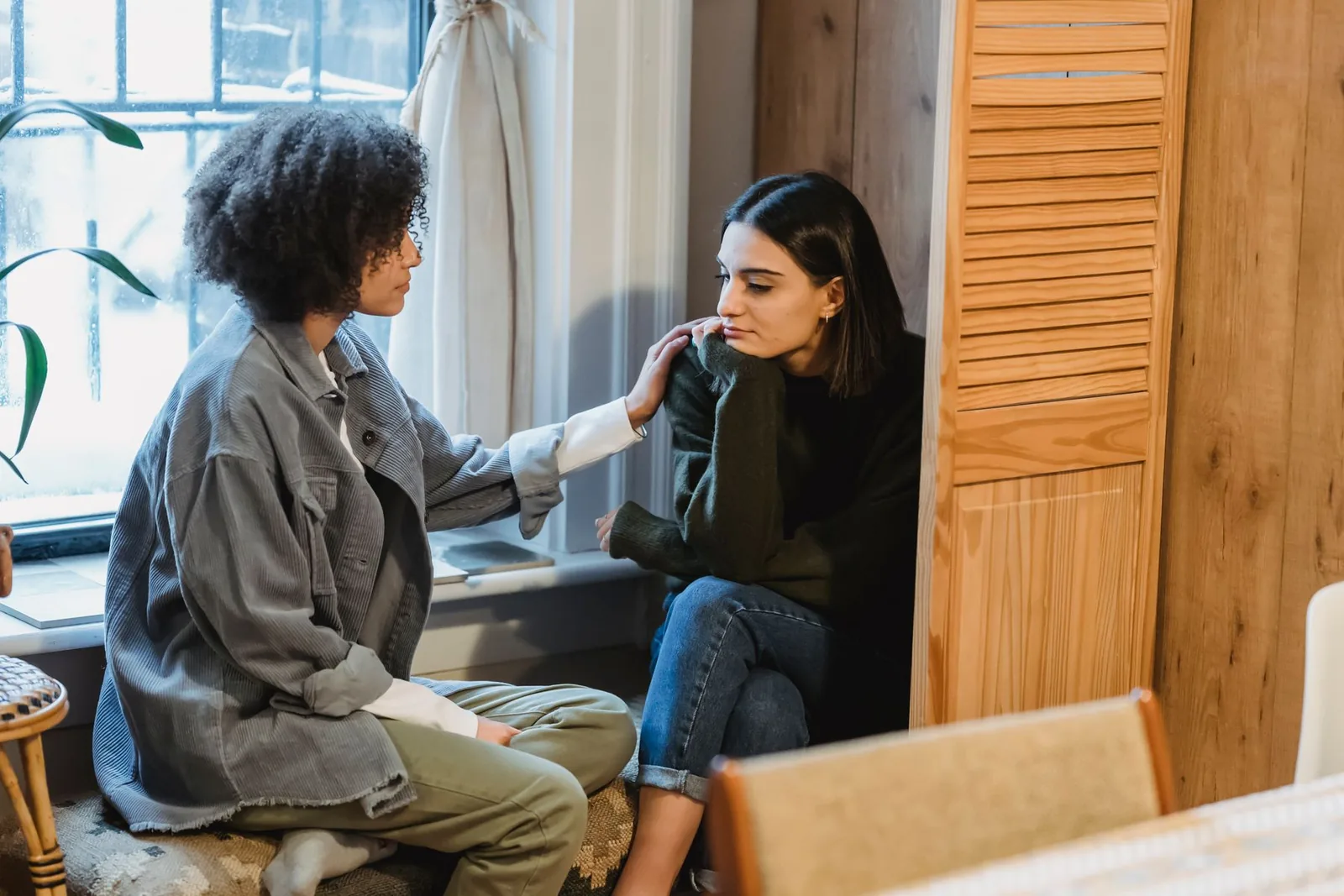 Two adults having a supportive conversation in a quiet setting