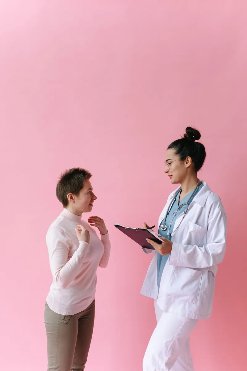 Adult writing symptom notes before a healthcare appointment