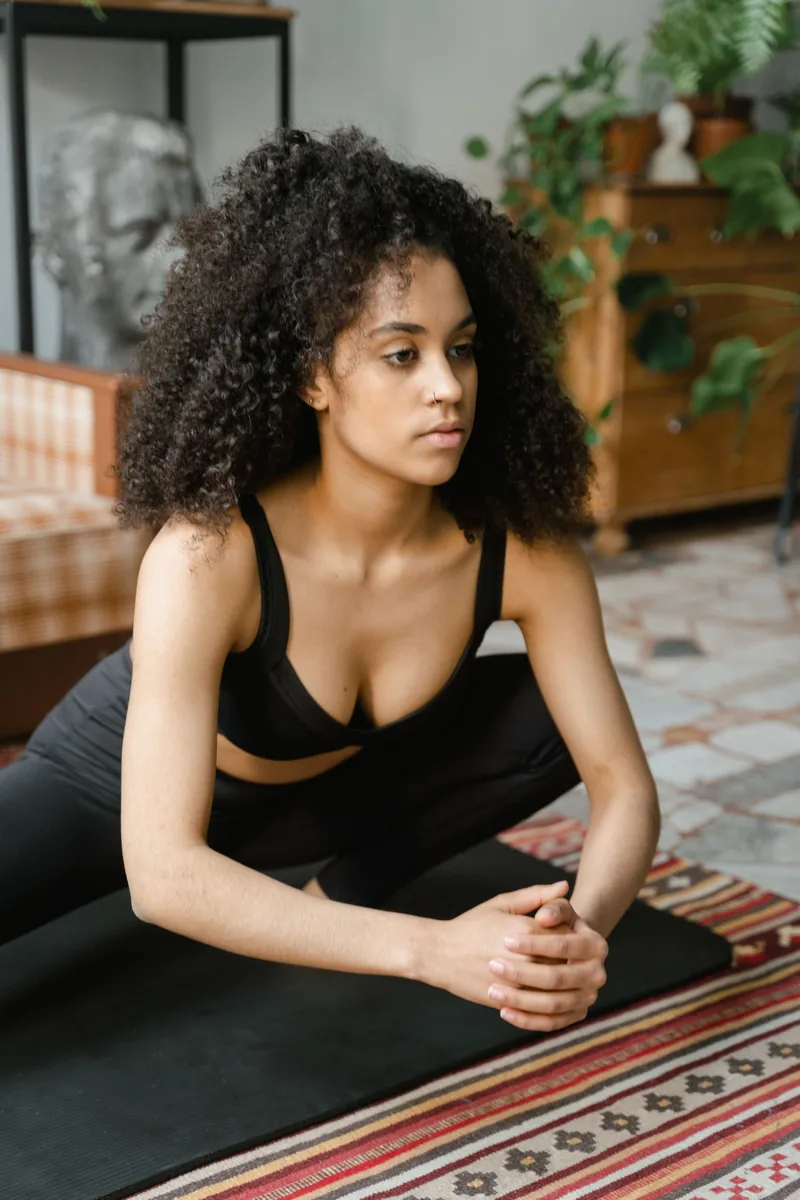 Adult practicing gentle yoga in a bright living room