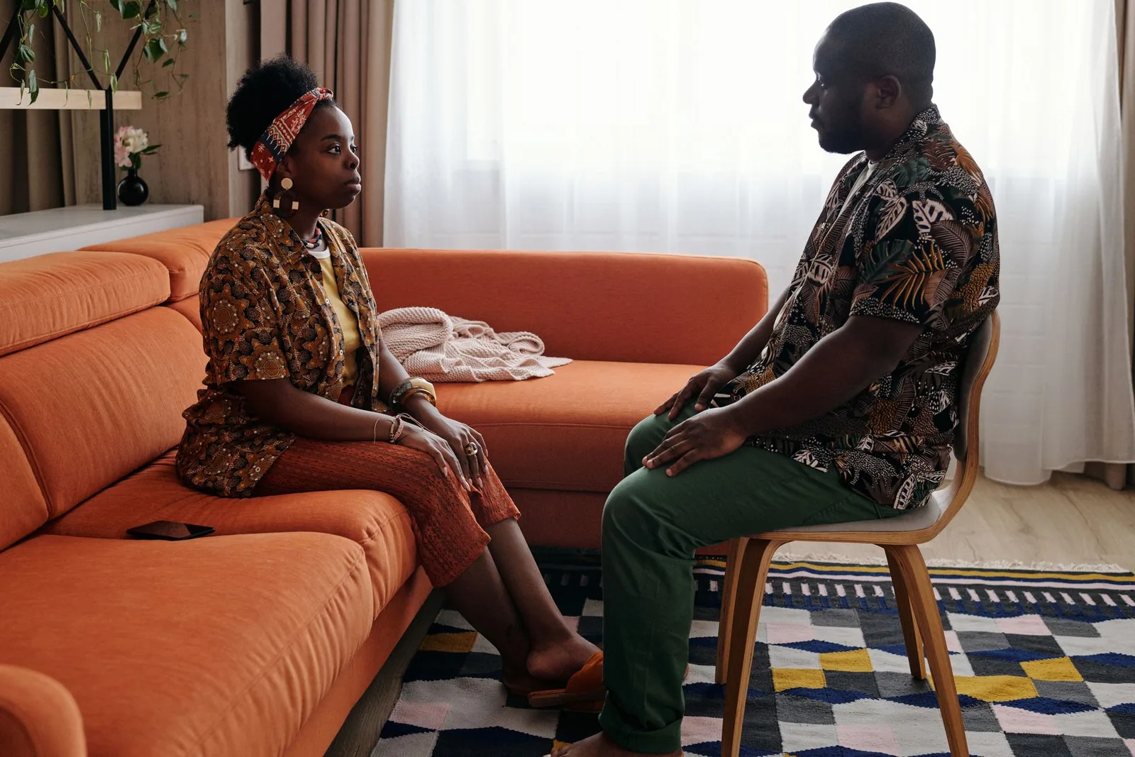 Couple talking attentively at a kitchen table